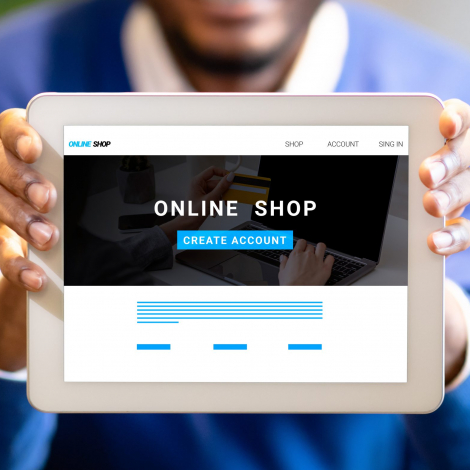 Home 27 Young black businessman showing tablet with online shop website on screen, creative collage. Panorama